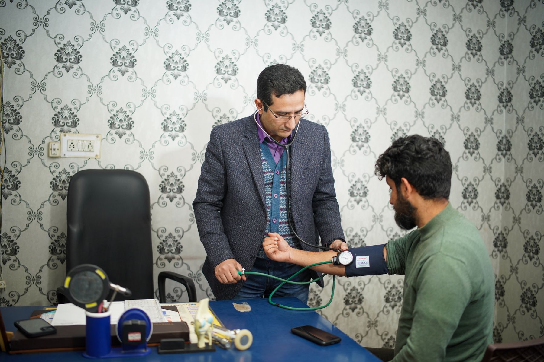 Medical examiner checking a patient's blood pressure