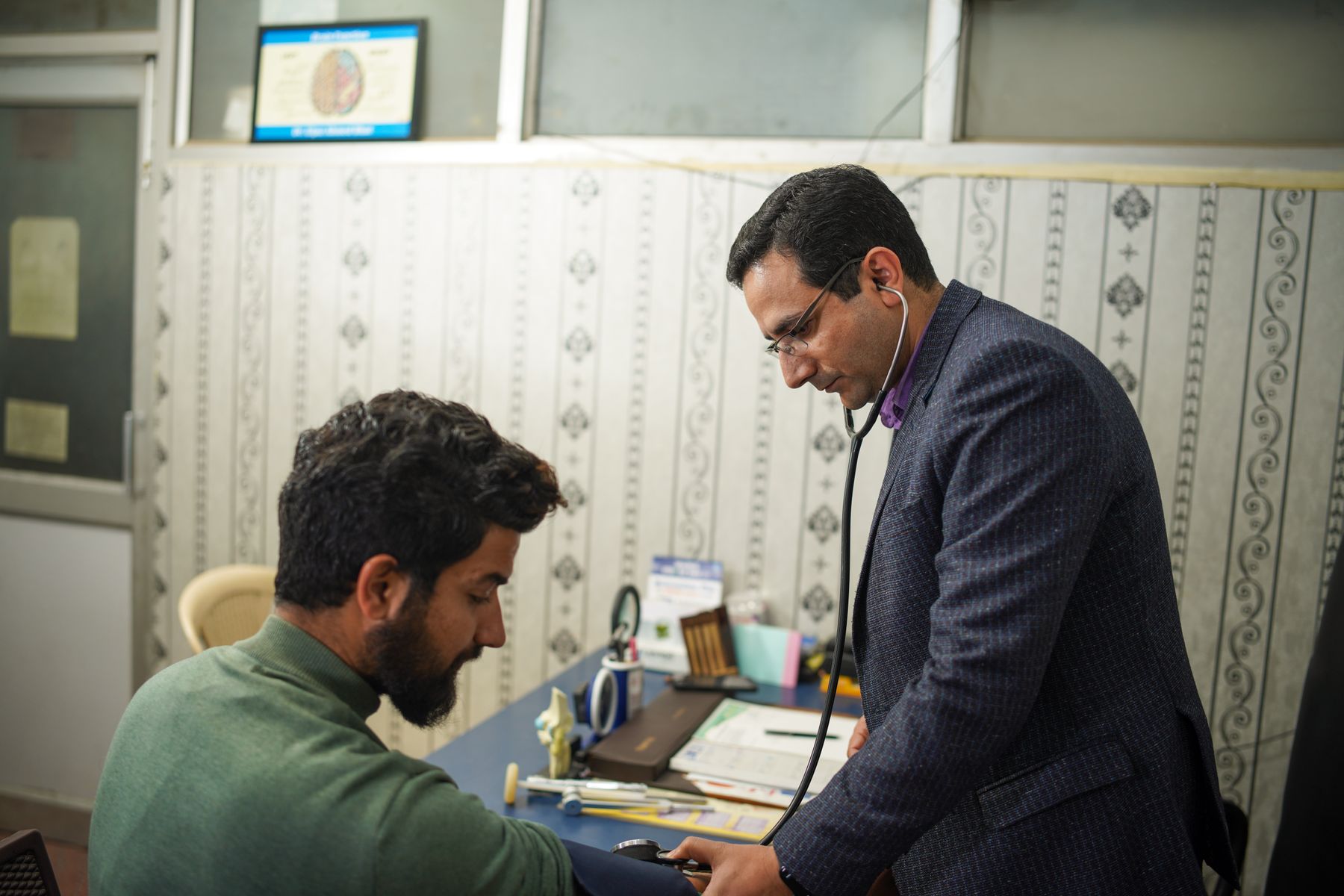 Medical examiner performing a routine stethoscope examination