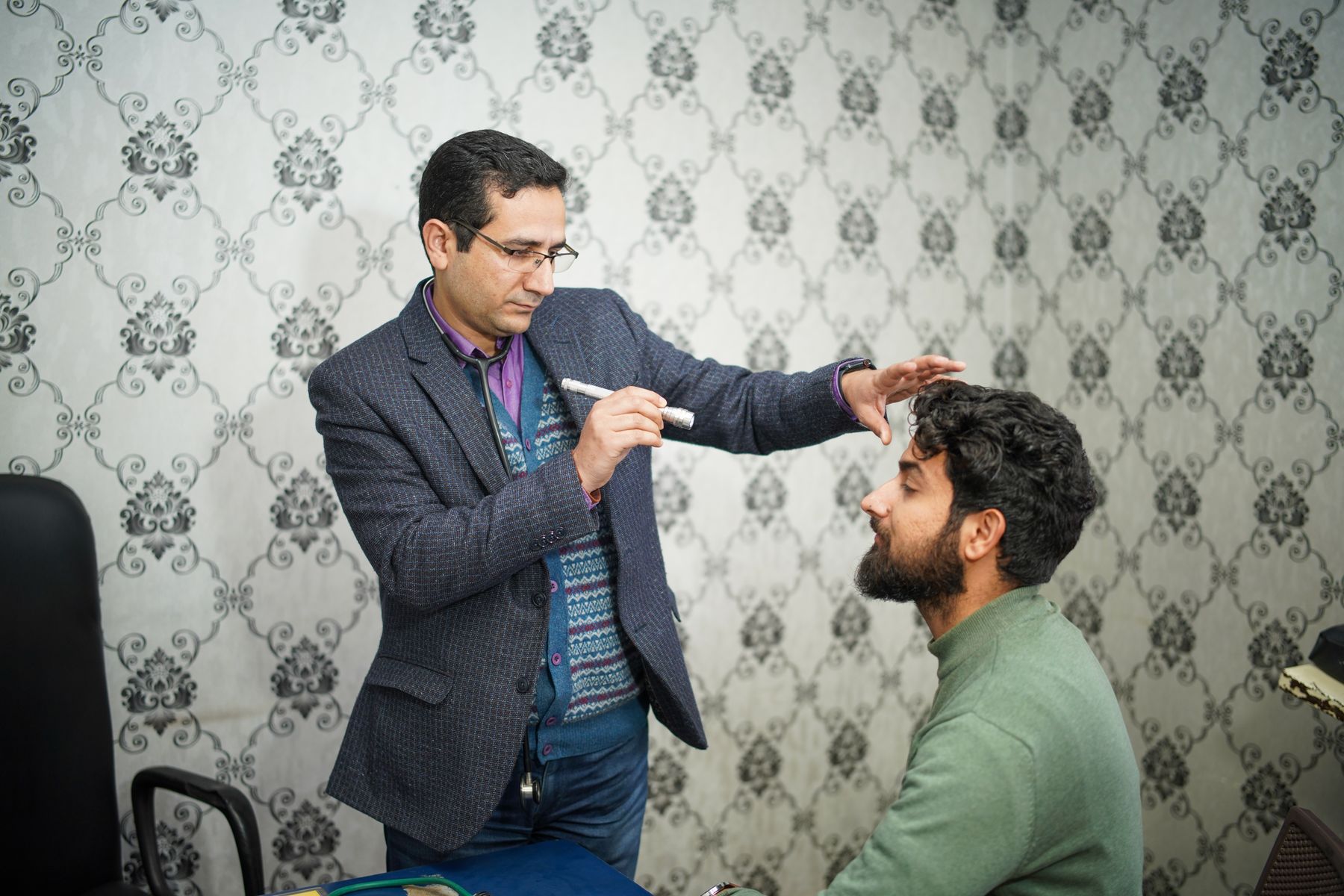 Medical examiner performing a patient's vision screening